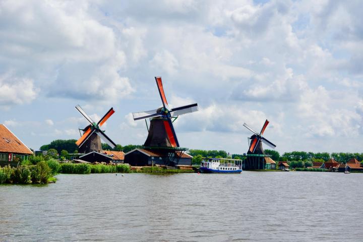 Four windmills next to a river